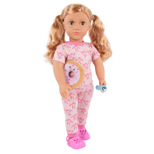 Doll dressed in pajamas holding flashlight and plush donut pillow