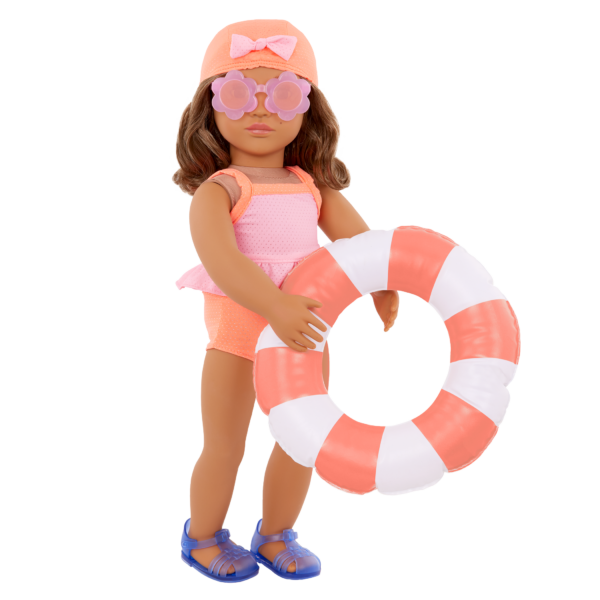 Our Generation Doll wearing the Deluxe Outfit "Floaty Fun", holding a donut shaped floatie and wearing a bathing cap and sunglasses