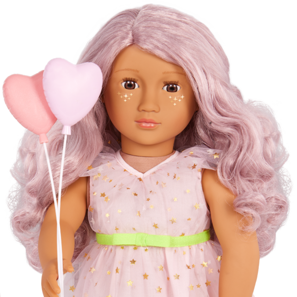 Close-up of Our Generation Doll Wishes holding balloons