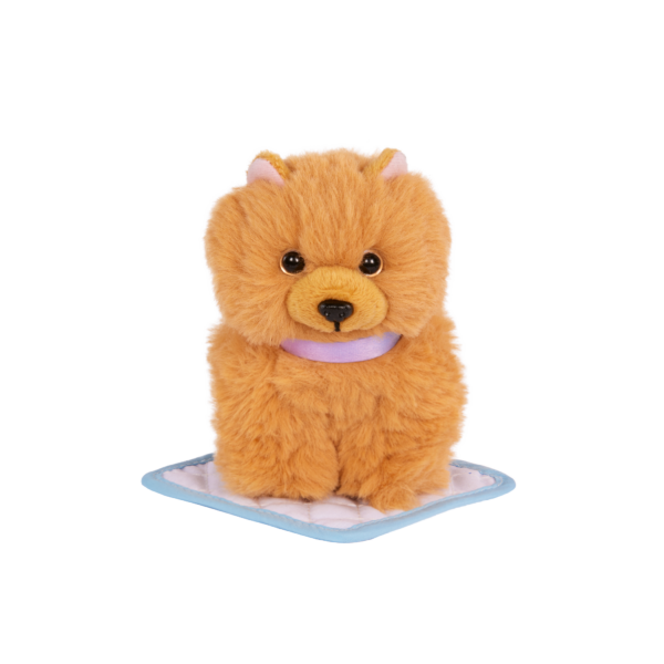 Our Generation Plush Dog Goldie sitting on training pad