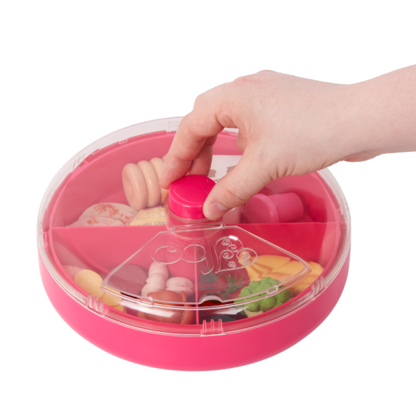 Child's Hand Spinning the Our Generation Play Food Storage Case