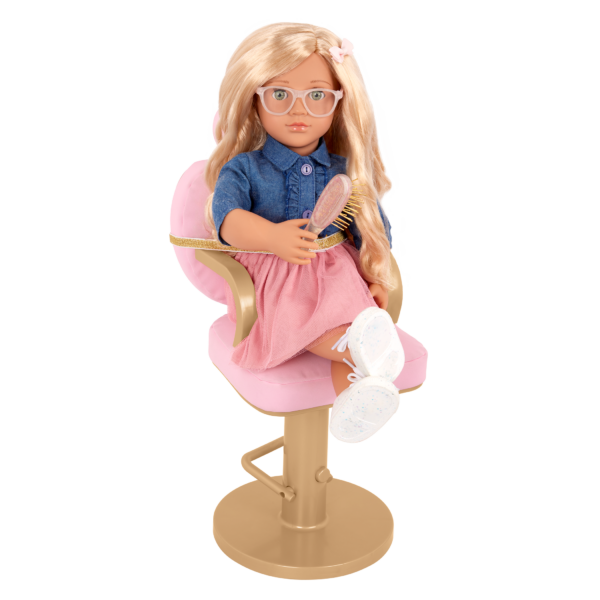 Our Generation 18" Doll sitting in salon chair holding hairbrush