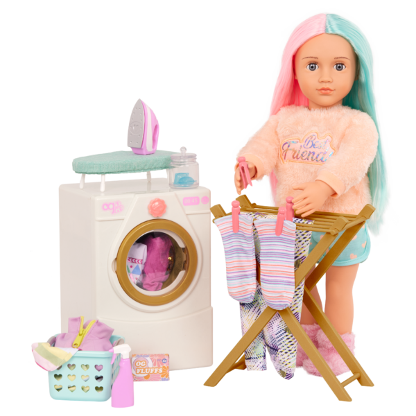 Our Generation 18 inch doll hanging socks to dry on drying rack, with clothes in the washing machine and other accessories