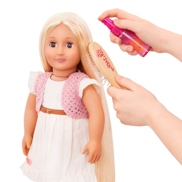 Child Spraying Water on Doll's Hair with Spray Bottle