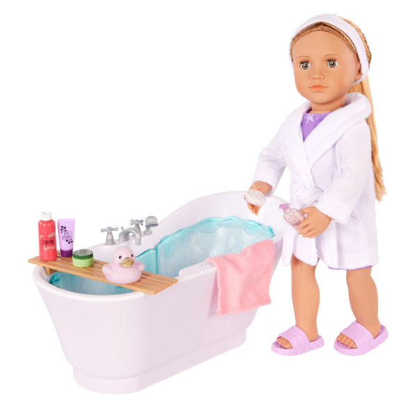 Our Generation 18-inch Doll standing beside a Bathtub with bath accessories