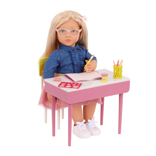 Our Generation Doll sitting at the desk