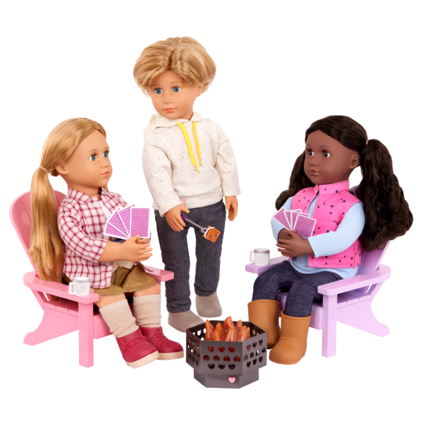 Two Our Generation Dolls sitting on the Adirondack Chairs playing cards and one OG Doll at the fire pit roasting marshmallows
