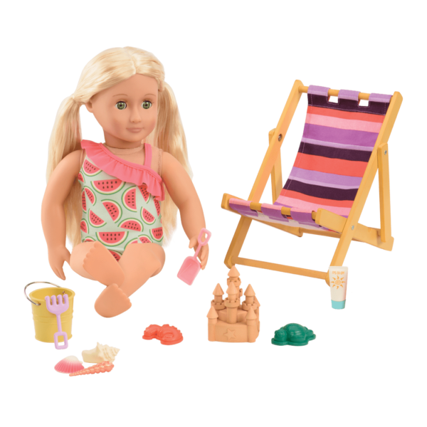 Ginger sitting and playing with beach toys