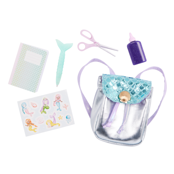 Our Generation Doll Shiny Silver and Teal Backpack with shell closure and accessories including mermaid stickers, notebook, scissors, glue bottle, mermaid pen