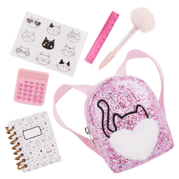 Our Generation Doll Sparkly Pink Backpack with cat motif and accessories including cat stickers, notebook, calculator, ruler and pen